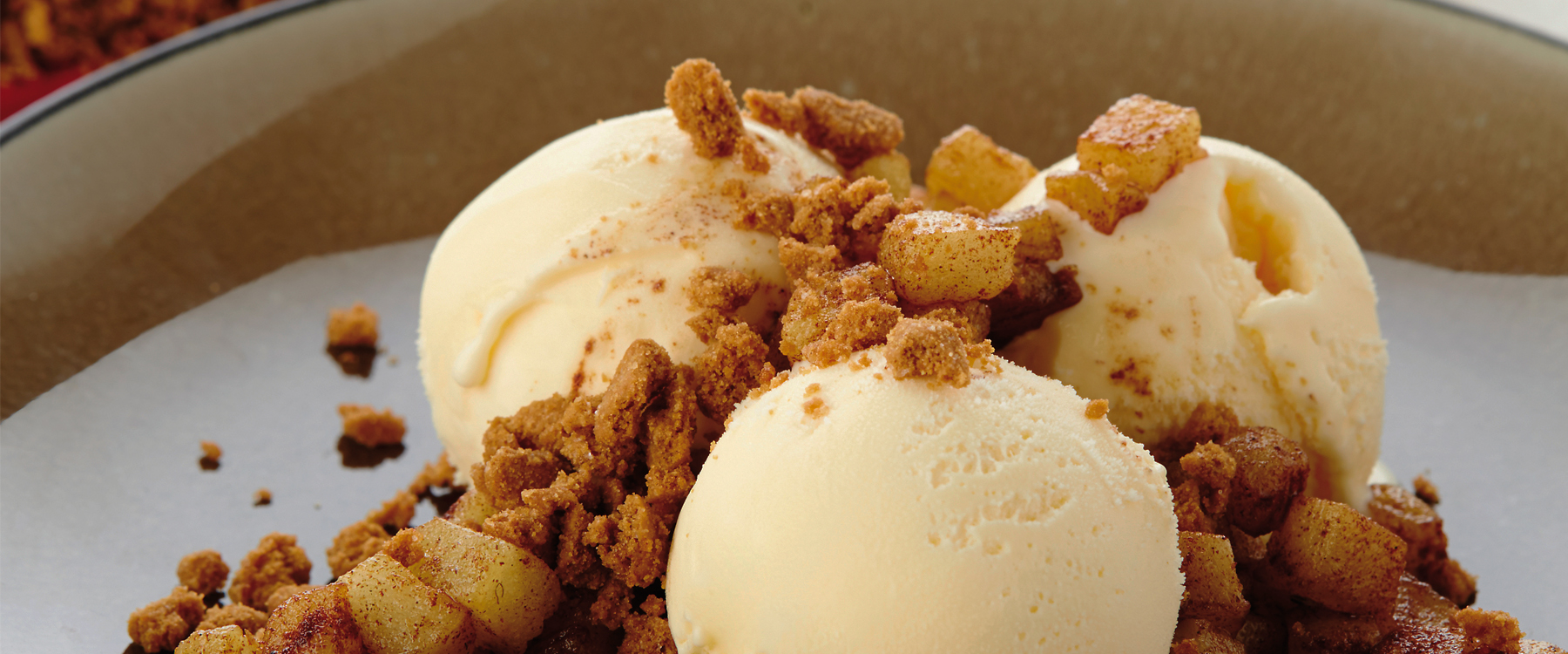 Vanilla ice cream with fried apple and Lotus Biscoff crumbles